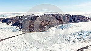 Greenlandic melting ice sheet glacier aerial view from the plane, near Kangerlussuaq, Greenland photo