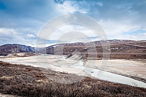 Greenlandic wastelands landscape with river and mountains in the