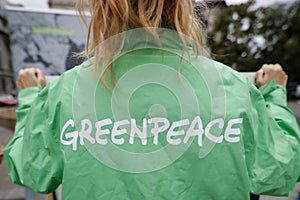 Greenpeace activist holding a banner at a protest