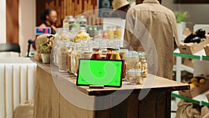 Greenscreen display shown on tablet at neighborhood grocery store