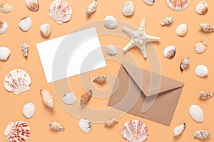 Greeting blank mockup card, brown envelope and seashells collection on pastel yellow background. Stationery still life in beach