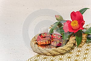 Greeting card with a camellia and two figurines of Japanese Shishi lions.