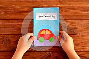 Greeting card father's day. Child holds a greeting card in his hand. Happy father's day. Easy kids crafts