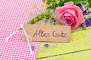 Greeting card with german text, Alles Gute, means best wishes and romantic rose flower bouquet