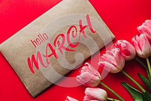 Greeting card with the inscription Hello March. Bouquet of pink Tulip flowers