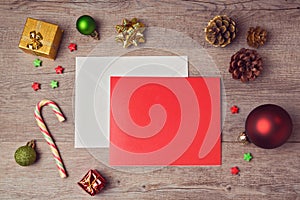 Greeting card mock up template with Christmas decorations on wooden background. View from above
