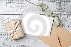 Greeting card mockup with envelope and holidays gift box