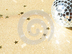 Greeting card - New year or Christms with silver disco ball and golden star shape glitter on gold shine background