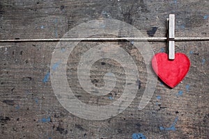 Greeting card with red heart on wooden surface