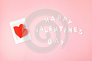 Greeting card with red paper hearts and text Happy valentines day over pink background. Love, saint valentines day concept
