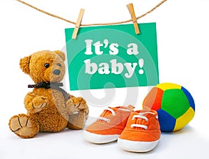 Greeting card it's a baby, tedy bear, baby's sneakers, colorful