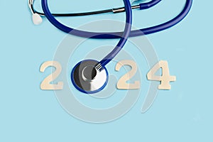 2024 greeting card with an stethoscope in the shape of cero on a blue background photo