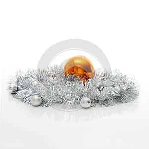 Greeting card template made of silver tinsel with silver and orange christmas balls with copy space, horizontal view