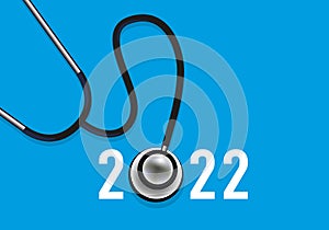 Greeting card 2022, on the theme of health symbolized by a stethoscope on a red background. photo