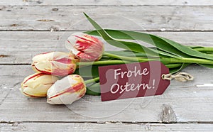 Greeting card with tulips and german text: Happy Easter