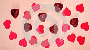 Greeting card for Valentine`s Day or Women`s Day. Red hearts on a pink marble background, flat lay. Congratulations on the holid