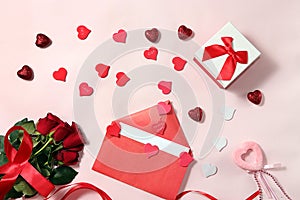 Greeting card for Valentine`s Day or Women`s Day. Red roses with ribbon and a love letter with hearts on a pink background.