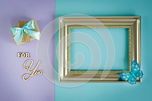 Greeting card for You on a purple - mint background with gift boxes, butterfly and frame.