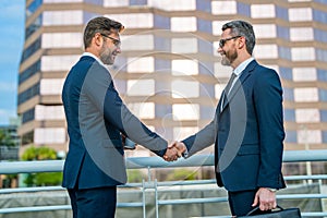 Greeting, dealing, merger and acquisition concept. Handshake between two business men. Two businessmen shaking hands on