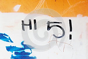 Graffiti tag hi 5 written on grungy wall