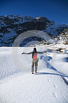 Greeting hiking woman on snow
