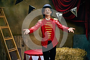 Greeting. Illusionist or showman. Happy excited man, retro circus entertainer announces start of show isolated over dark