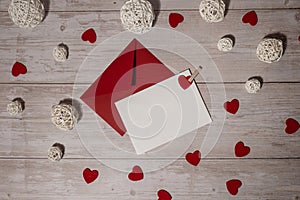 Greeting or invitation card mock up with red envelope on wooden background. Romantic Small hearts Valentine day. Blank