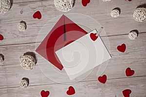 Greeting or invitation card mock up with red envelope on wooden background. Romantic Small hearts Valentine day. Blank