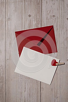 Greeting or invitation card mock up with red envelope on wooden background. Romantic Small hearts Valentine day. Blank