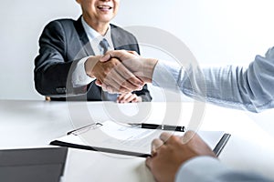 Greeting new colleagues, Handshake while job interviewing, male candidate shaking hands with Interviewer or employer after a job