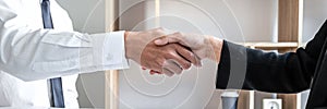 Greeting new colleagues, Handshake while job interviewing, male candidate shaking hands with Interviewer or employer after a job
