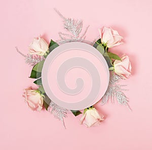 Greeting round form blank mock up and pink roses top view on pink background. Flat lay. Copy space.