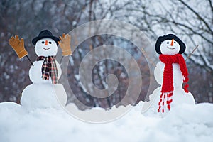 Greeting snowman. Happy smiling snow man on sunny winter day. Merry Christmas and Happy new year. Two Snowman on snow