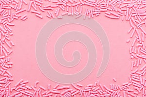 greeting wreath of sprinkles over pink background, festive invitation for Valentines day, birthday, holiday and party time