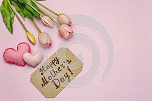 Greetings card for Happy Mothers Day. Gentle pink tulips, handmade felt hearts