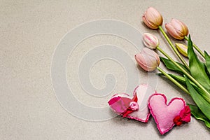 Greetings card, wallpaper, backdrop. Mothers Day, St.Valentines or Wedding. Gentle pink tulips, handmade felt hearts