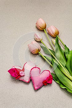 Greetings card, wallpaper, backdrop. Mothers Day, St.Valentines or Wedding. Gentle pink tulips, handmade felt hearts