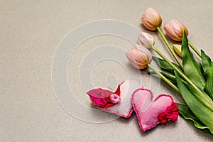 Greetings card, wallpaper, backdrop. Mothers Day, St.Valentines or Wedding. Gentle pink tulips, handmade felt hearts