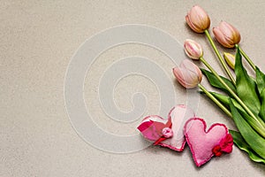 Greetings card, wallpaper, backdrop. Mothers Day, St.Valentines or Wedding. Gentle pink tulips, handmade felt hearts