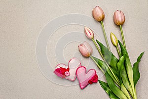 Greetings card, wallpaper, backdrop. Mothers Day, St.Valentines or Wedding. Gentle pink tulips, handmade felt hearts