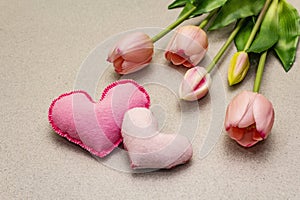 Greetings card, wallpaper, backdrop. Mothers Day, St.Valentines or Wedding. Gentle pink tulips, handmade felt hearts