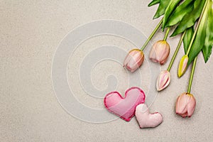 Greetings card, wallpaper, backdrop. Mothers Day, St.Valentines or Wedding. Gentle pink tulips, handmade felt hearts