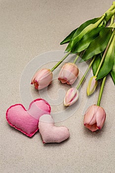 Greetings card, wallpaper, backdrop. Mothers Day, St.Valentines or Wedding. Gentle pink tulips, handmade felt hearts