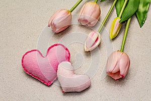 Greetings card, wallpaper, backdrop. Mothers Day, St.Valentines or Wedding. Gentle pink tulips, handmade felt hearts