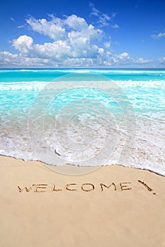 Greetings welcome beach spell written on sand