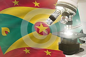 Grenada science development concept - microscope on flag background. Research in pharmaceutical industry or biology 3D