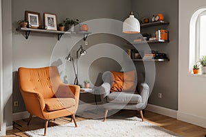 Grey armchair next to lamp in orange vintage living room interior with sofa next to cabinet