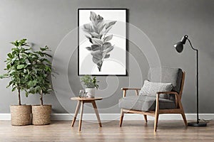 Grey armchair next to a wooden table in living room interior with plant and poster.