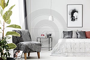 Grey armchair in bedroom