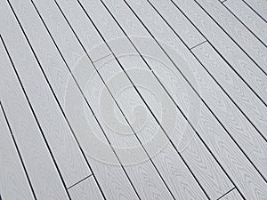 Grey artificial or composite wood boards on deck with lines